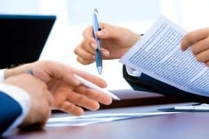 Two people planning with purpose writing and estate planning.