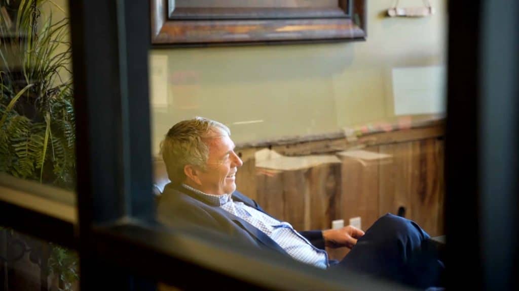 A Matt Data smiling and sitting comfortably in a cozy office setting.