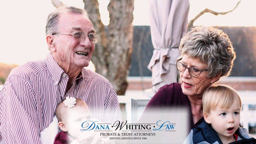 Elderly man and woman with a young girl outdoors, legal professionals discussing estate planning.
