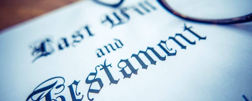 A woman reading a legal document titled "East St. and Testament" for estate planning.