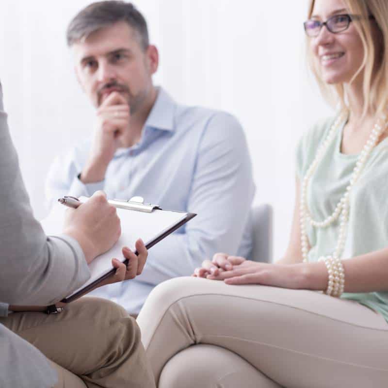 Legal consultation with a lawyer and client in a professional office setting.