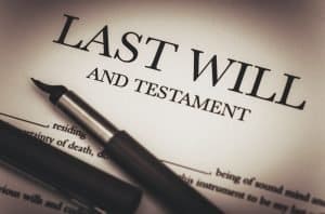 Estate planning legal document with a pen on "Last Will and Testament" form.