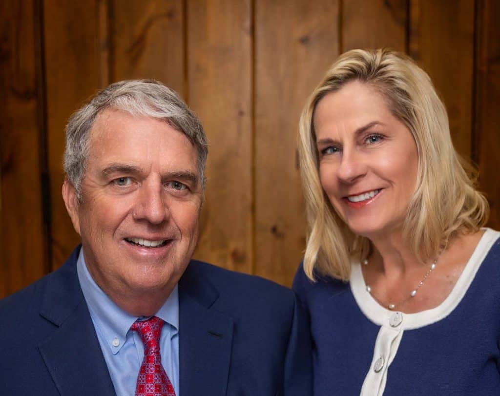 Mr. and Mrs. Dana posing for a photo in a professional office setting.