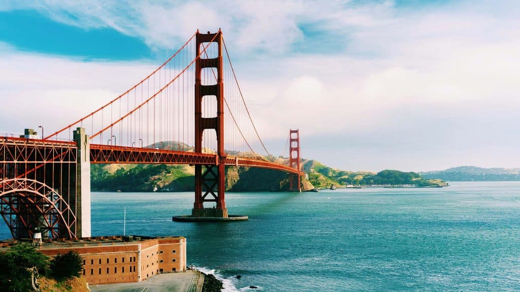 Golden Gate Bridge in San Francisco, California, with scenic water views and clear sky.