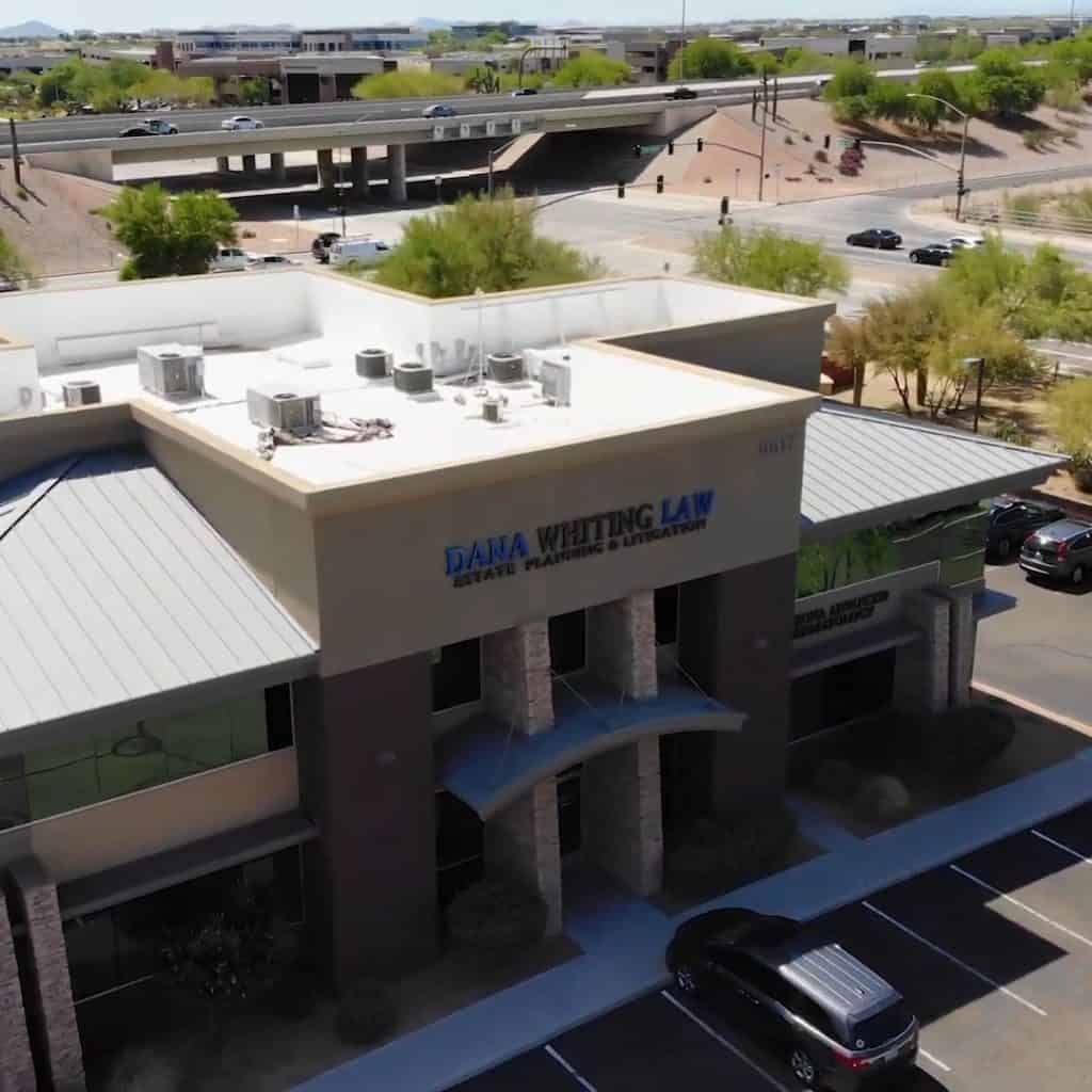 Dana Whiting Law office building in a commercial area with parking and surrounding greenery.