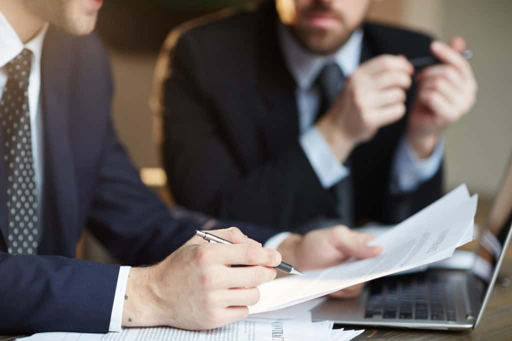 Legal consultation between attorneys discussing case details.