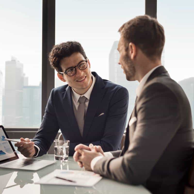 Business professionals discussing legal services in a modern office setting.