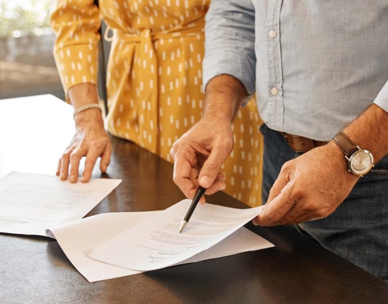Business professionals reviewing legal documents in an office setting.