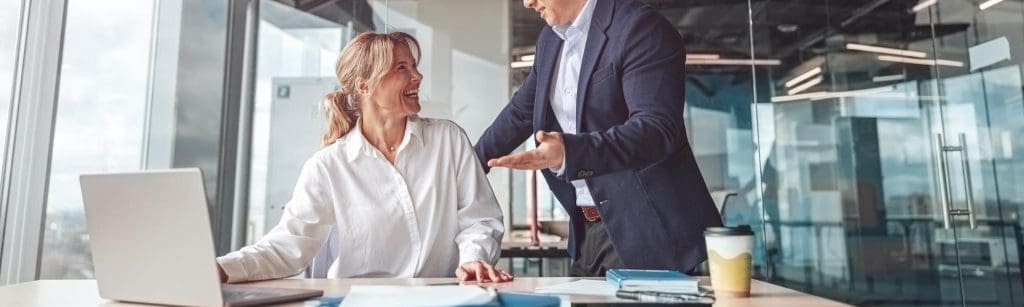 Business professionals discussing legal matters in a modern office setting.