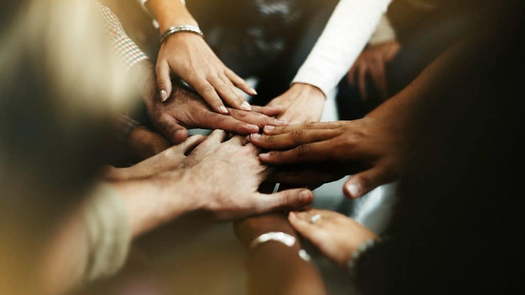 Hands joined together in a show of unity and support at Dana Whiting Law.