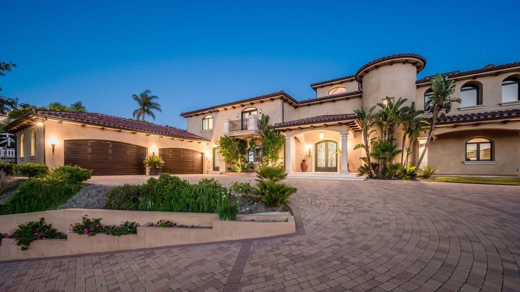 Luxury residential estate with lush landscaping and elegant architecture in a sunny climate.