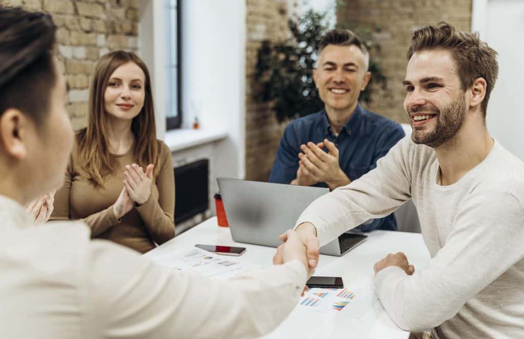Business professionals in a legal consultation with Dana Whiting Law team.