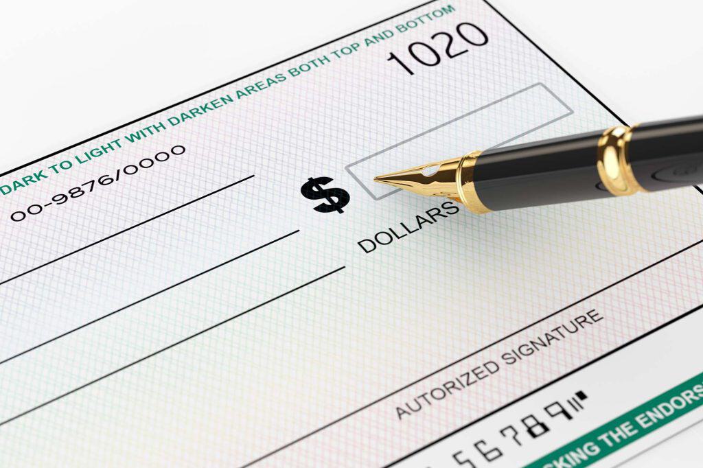 Bank check with a pen ready for payment processing.