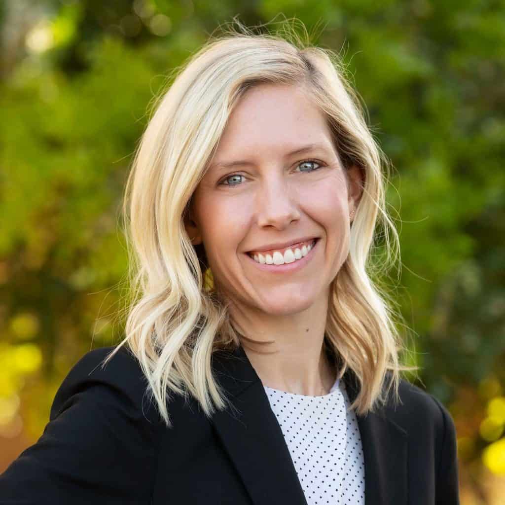 Professional woman lawyer smiling outdoors, legal expert, Dana Whiting Law.